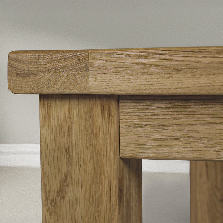 The side of the Amstel Square Oak Coffee Table. There is a coffee mug on top.