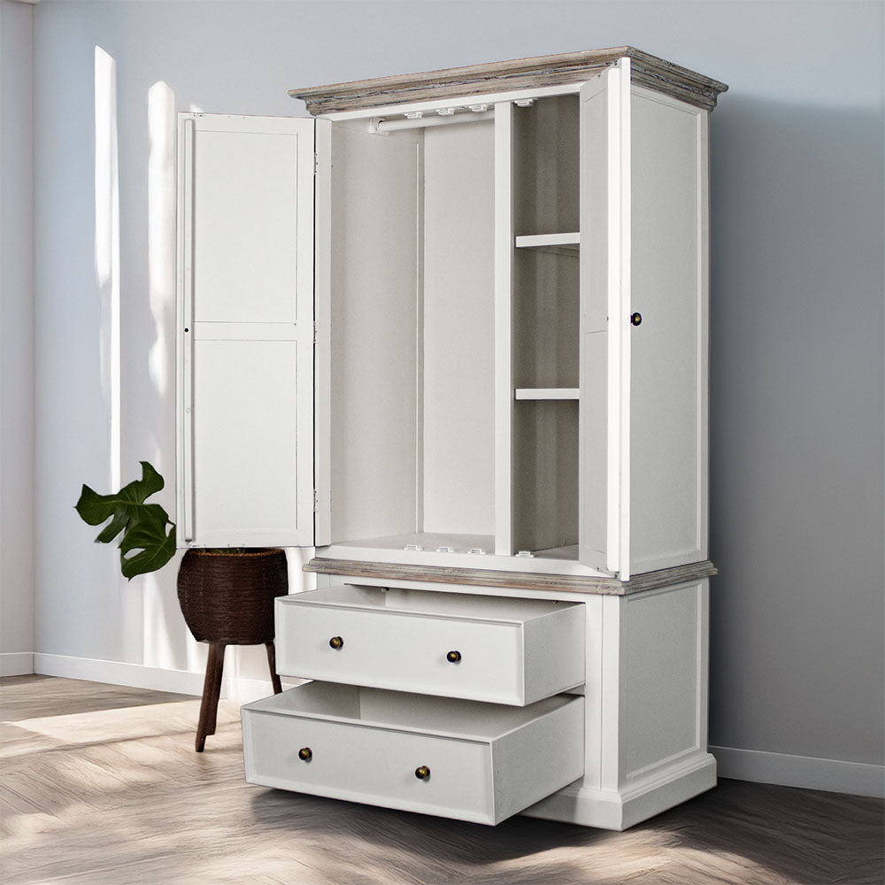 An overall view of the Biarritz Two-piece Wardrobe with its drawers and doors open. There is a free standing potted plant next to it.