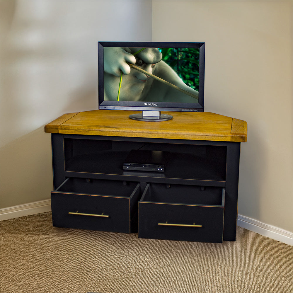 The front of the Cascais Oak-top Corner Entertainment Unit with its drawers open. There is a small TV on top and a DVD player on the shelf below it.