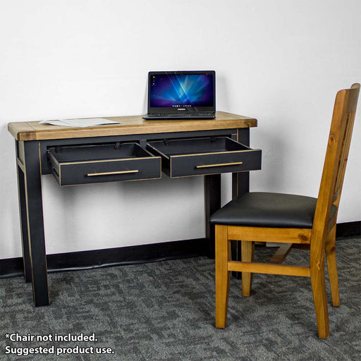 The front of the Cascais Black Desk with its drawers open. There is a laptop and papers on top of the desk and an upholstered pine dining chair in front.