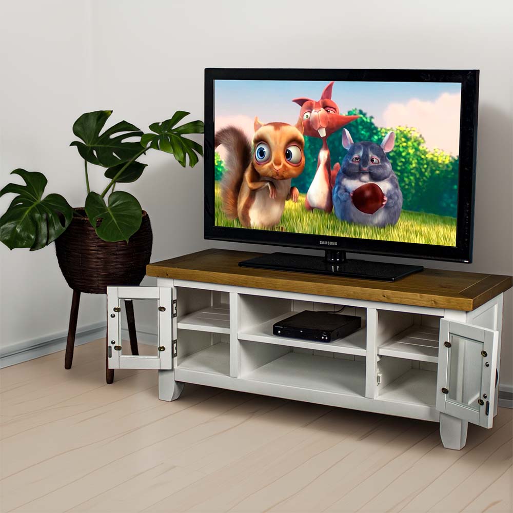 The front of the Felixstowe 2 Door Entertainment Unit with its doors open. There is a large TV on top, with a DVD player on the top shelf in the middle. There is a free standing potted plant next to the unit.