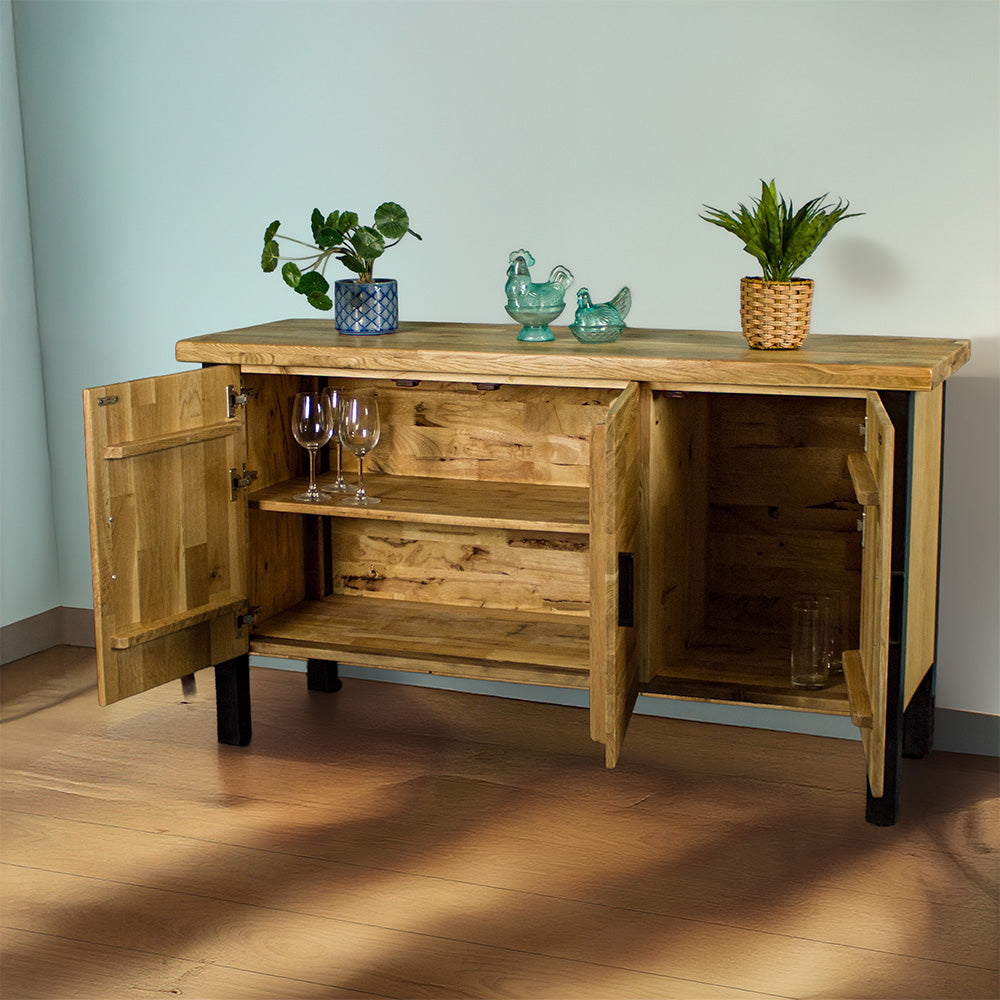 The front of the Golden Gate Three Door Oak Buffet with its doors open. There are two potted plants on top and two blue glass ornaments in between.