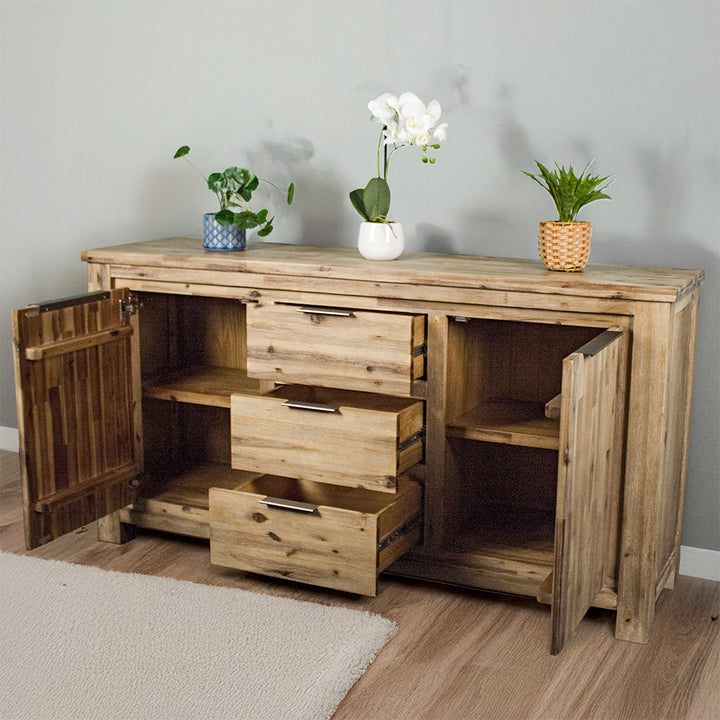 The front of the Mars 3 Drawer Large Buffet with its drawers and doors open. There are three potted plants on top.