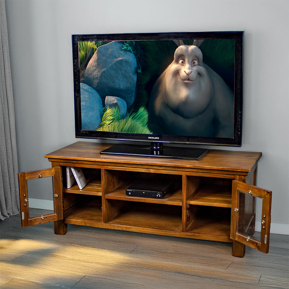 The front of the Montreal Entertainment Unit with its doors open. There is a large TV on top, a DVD player on the top shelf and two DVDs in the left cabinet.