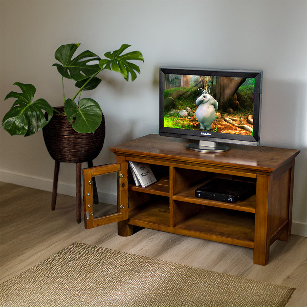 The front of the Montreal Small Entertainment Unit with its door open. There is a small TV on top, and a DVD player on the top shelf. There are two DVD cases on the left shelf. 