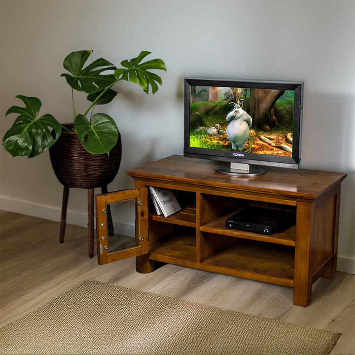 The front of the Montreal Small Entertainment Unit with its door open. There is a small TV on top, and a DVD player on the top shelf. There are two DVD cases on the left shelf. 