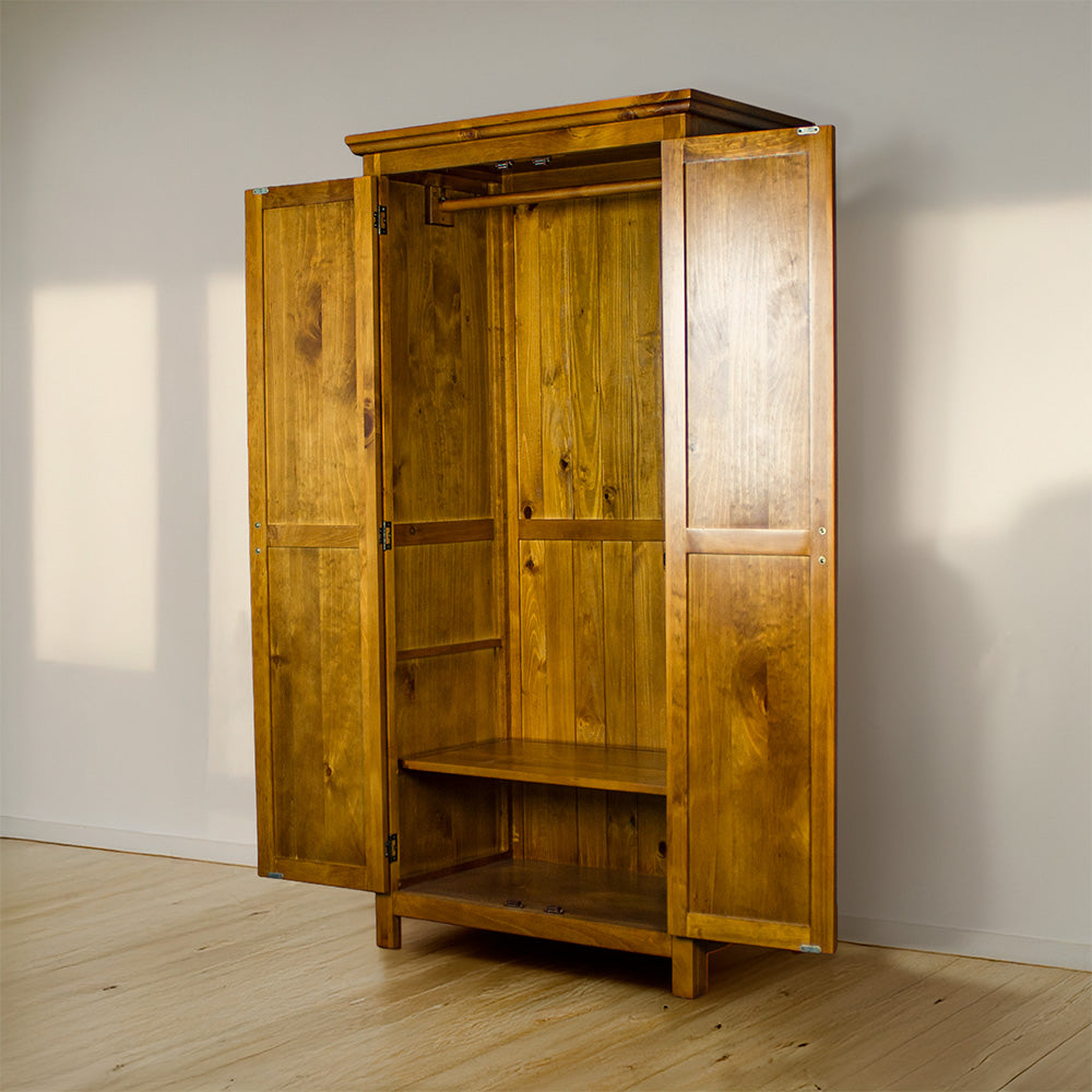 The doors open on the Montreal Full Length Pine Wardrobe showing the adjustable lower shelf