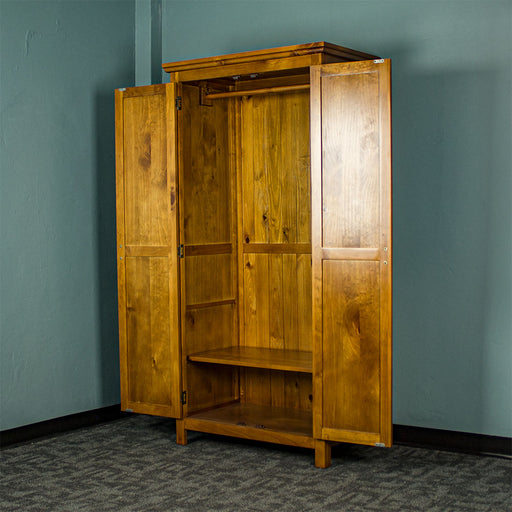The doors open on the Montreal Full Length Pine Wardrobe showing the adjustable lower shelf