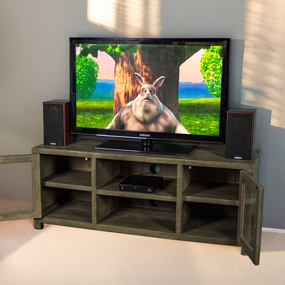 The front of the Stonemill Recycled Pine TV Unit with its doors open and a TV and two speakers on top. There is a DVD player in the top shelf in the middle.