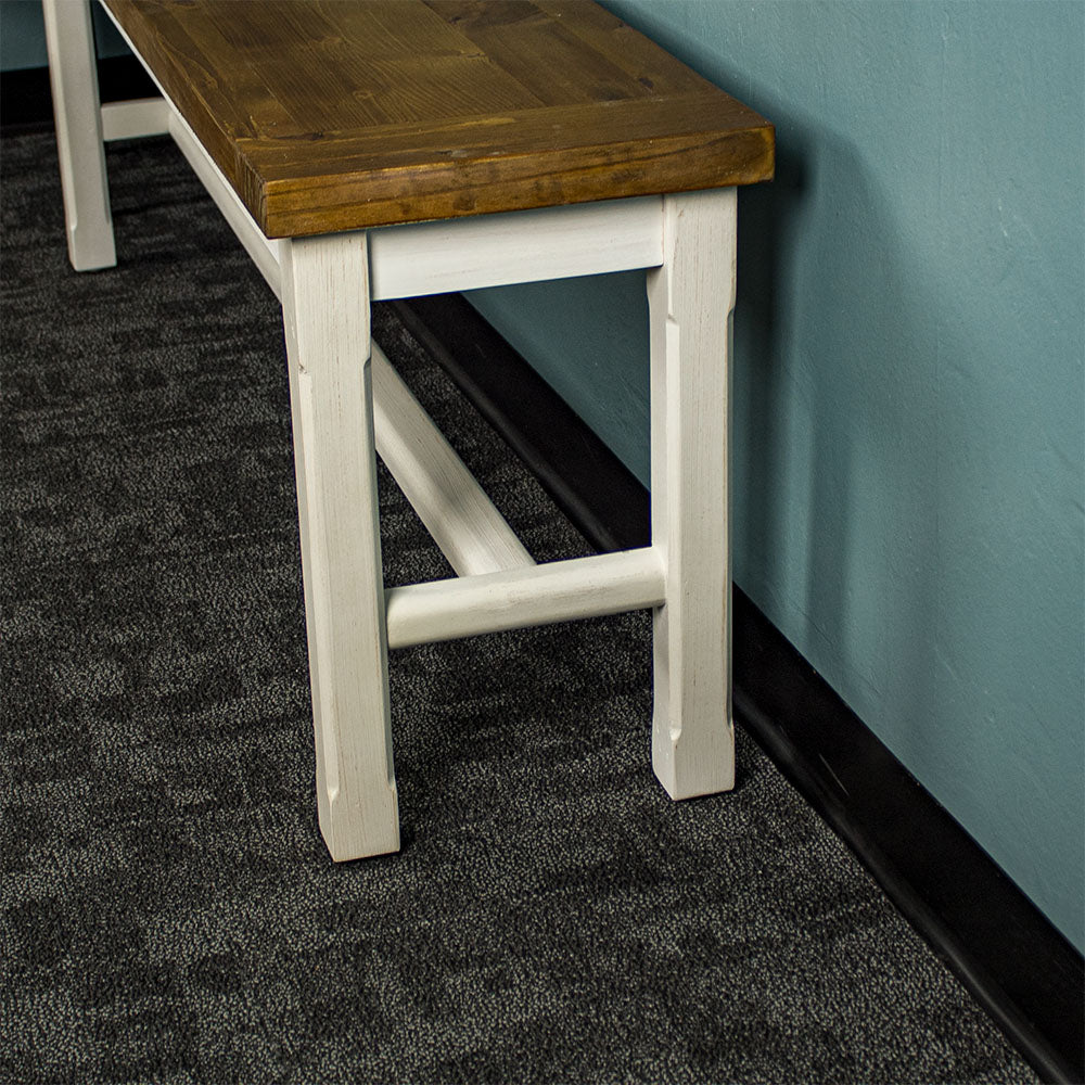 Side of the Tuscan Recycled Pine Bench showing the legs and support bar.