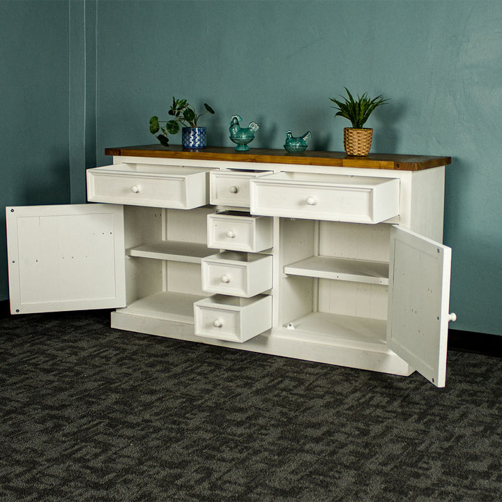 The front of the Tuscan Recycled Pine Buffet with its drawers and doors open, there are two potted plants on top and two blue glass ornaments.