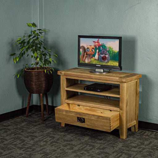 The front of the Vancouver Value Oak Entertainment Unit with its drawer open. There is a DVD player on the top shelf and a free standing potted plant next to the TV unit.