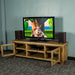 An overall view of the Ventura Recycled Pine Medium TV Unit with its drawers open,. There is a TV on top, with two bookcase speakers on either side and a DVD player on the top shelf in the middle of the unit.