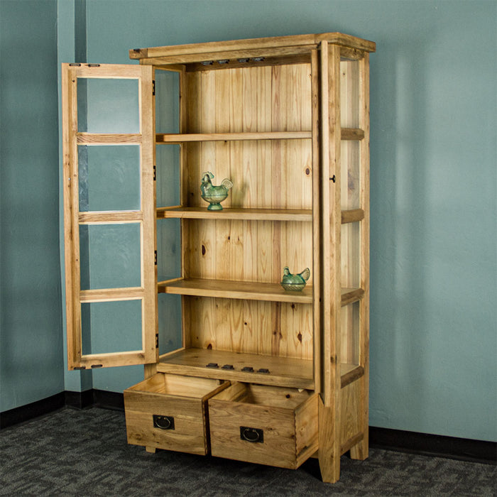 The front of the Vienna Oak Glass Display Cabinet with its doors and drawers open. There are two blue glass ornaments on the middle two shelves.