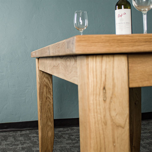 The side of the Yes Oak Dining Table (1.4m).