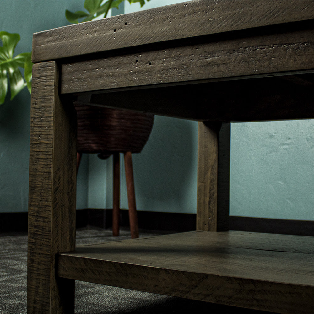 Close up of the table legs of the Stonemill Recycled Pine Coffee Table. The lower shelf is also seen.