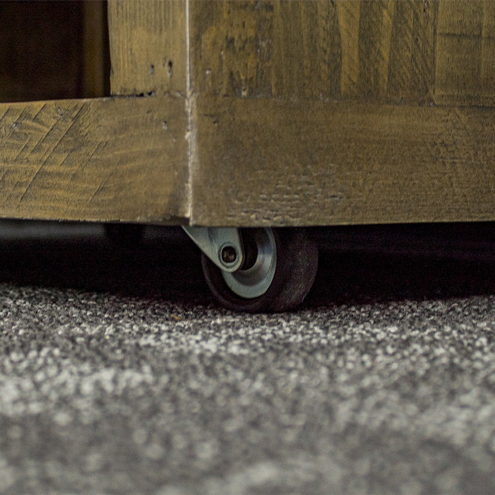 A close up of the wheels on the Stonemill Recycled Pine Cube Shelf, allowing the shelf to be easily moved.