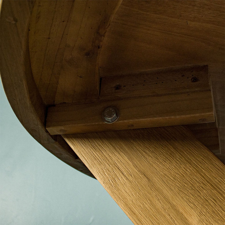 Close up of one of the bolts that secure the legs of the Amstel Round Oak Dining Table