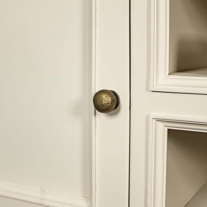 A close up of the brushed brass handle on the doors of the Biarritz Entertainment Unit.