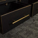 A close up of the gold coloured metal handle on the Cascais Oak Low Bookcase.