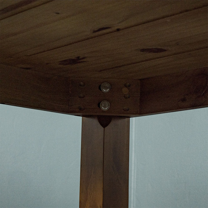 A close up of the bolts that securely hold the legs to the Hamilton Rimu Stained Dining Table (1500mm)