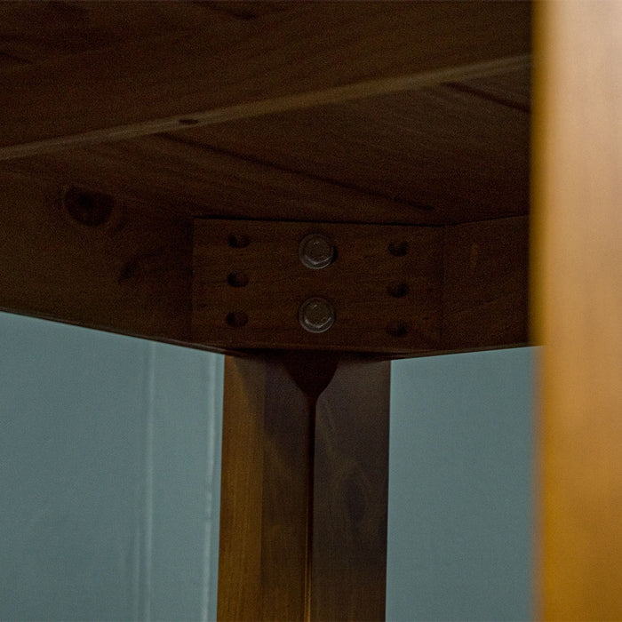 Underneath the Hamilton Square Pine Dining Table (1m), there are two bolts for each leg that secure them to the table.