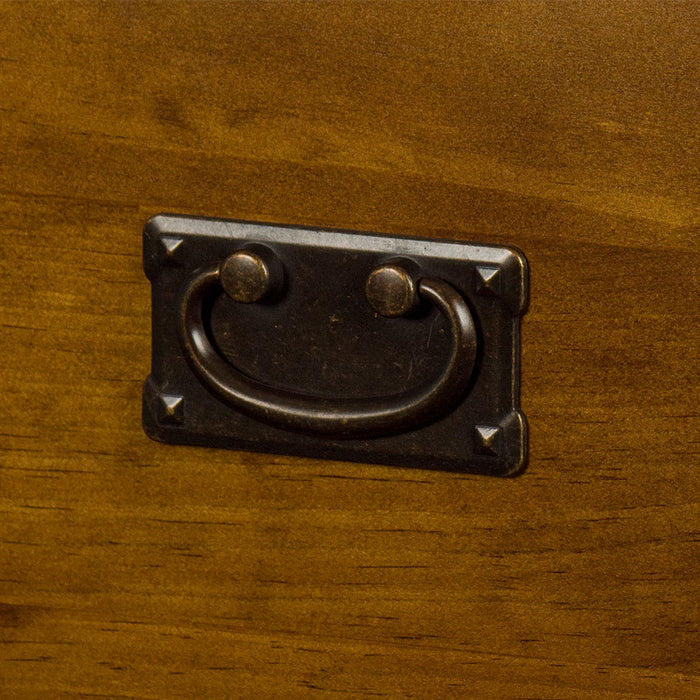 A close up of the brushed black metal handle on the Montreal Five Drawer Pine Tallboy.