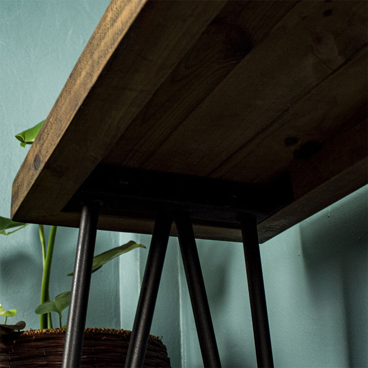 View of under the Paddington Recycled Pine Hall Table, showing the black metal legs bolted to the body.