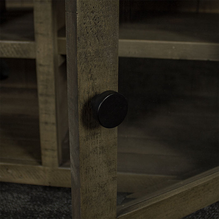 The black metal handle on the doors of the Stonemill Recycled Pine TV Unit