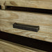 A close up of the brushed black metal handle on the drawers of the Vancouver 6 Drawer NZ Pine Tallboy.