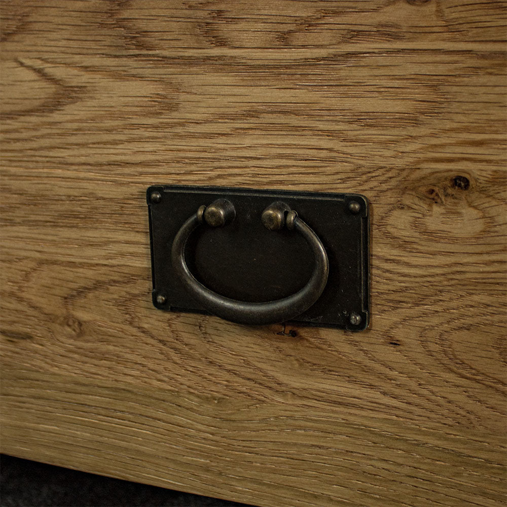 A close up of the hanging style drawer handle on the Vienna Oak Glass DIsplay Cabinet