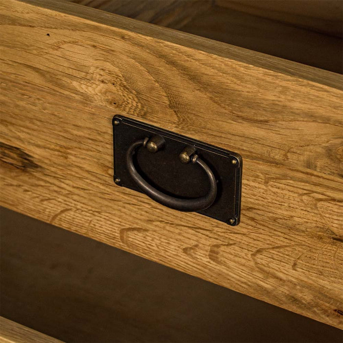 A close up of the handle on the drawers of the Yes Four Drawer Oak Lowboy.
