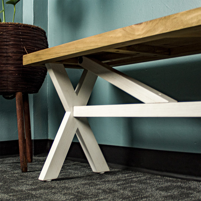 A close up of the support bar and brace of the Byron Recycled Pine Bench, which is attached to the cross legs