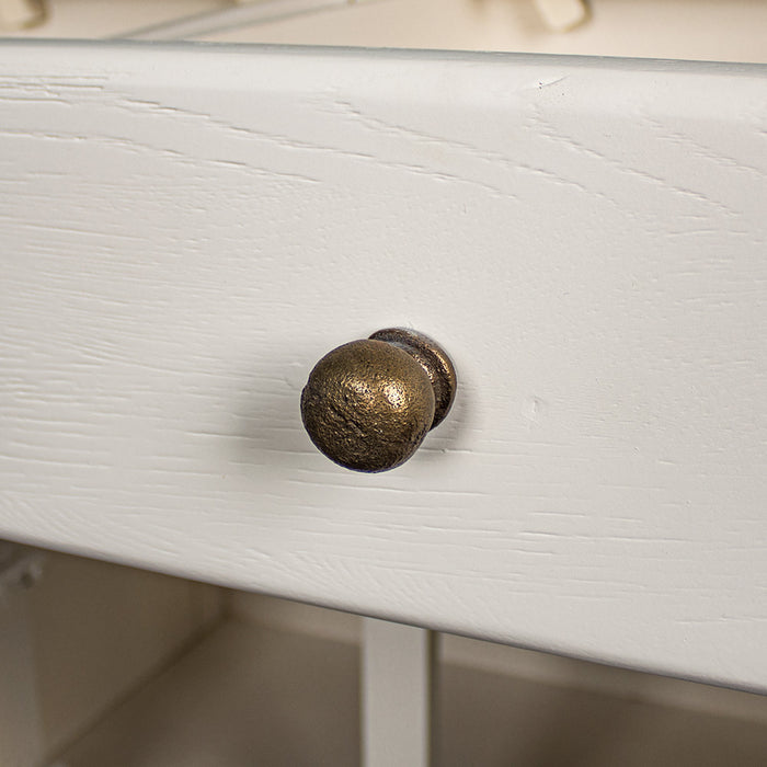 A close up of the brushed brass metal handle on the drawers and doors of the Loire Small Oak Buffet.