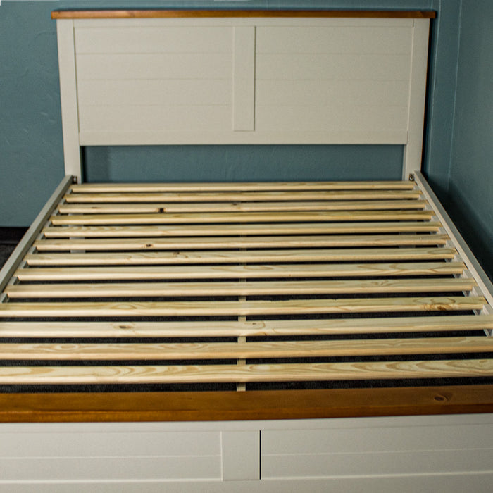 A front on view of the Alton Queen Size Pine Slat Bed Frame, showing the metal support bar underneath the slats.