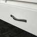 A close up of the silver metal handle on the drawers of the Felixstowe 1m Bookcase.