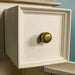 A close up of the brushed brass handle on the Biarritz Compact TV Unit.