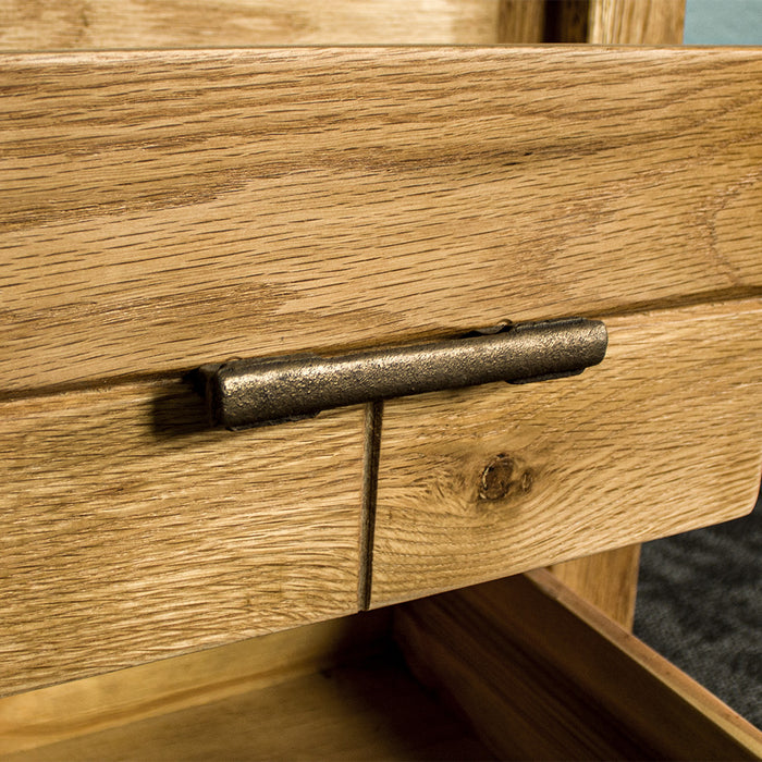 A closer view of the brushed brass coloured metal handle on the drawers of the Amalfi 2-Drawer Oak Bedside