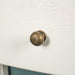 A close up of the brushed brass metal handle on the drawers of the Loire Oak Hall Table