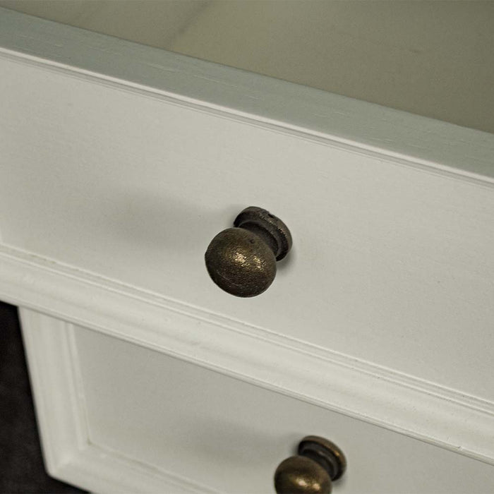 A close up of the brushed brass handle on the drawers of the Biarritz 3 Drawer Bedside Cabinet.