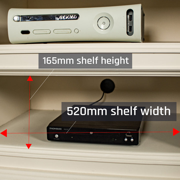 A closer view of the cable hole on the back of the Biarritz Entertainment Unit. There is a game console and a DVD player on the top and bottom shelves.