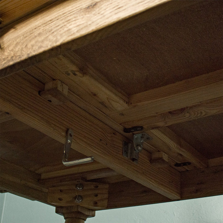 A view of the under side of the Boston Oak Extending Dining Table - Natural Oak.