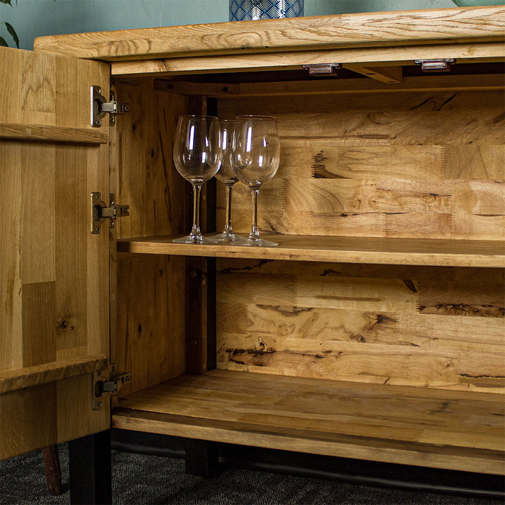 An overall view of the larger shelf on the Golden Gate Three Door Oak Buffet.