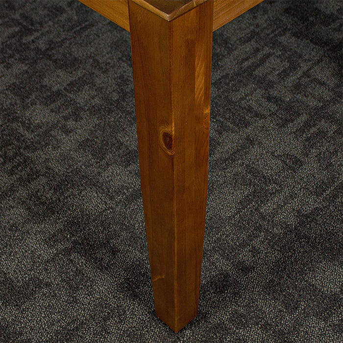 A close up of the leg of the Hamilton Dining Table with Rimu Finish (1.8m)