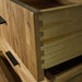 A close up of the strong dovetail joinery on the drawers of the Ormond 8 Drawer Oak Tallboy.
