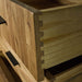 A close up of the strong dovetail joinery on the drawers of the Ormond 8 Drawer Oak Tallboy.