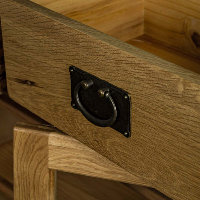 A close up of the hanging-style handle on the drawer of the Vancouver Value 2 Drawer 2 Door Oak Sideboard.
