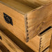 A close up of the dovetail joinery on the Yes Four Drawer Oak Tallboy.