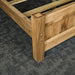 A closer view of the strong bolts that connect the side rails to the footboard of the Amalfi Oak Queen Bed Frame.