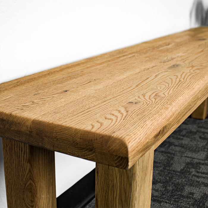 A close up of the top of the Loire Solid Oak Bench Seat 1.8m, showing the wood grain and colour.